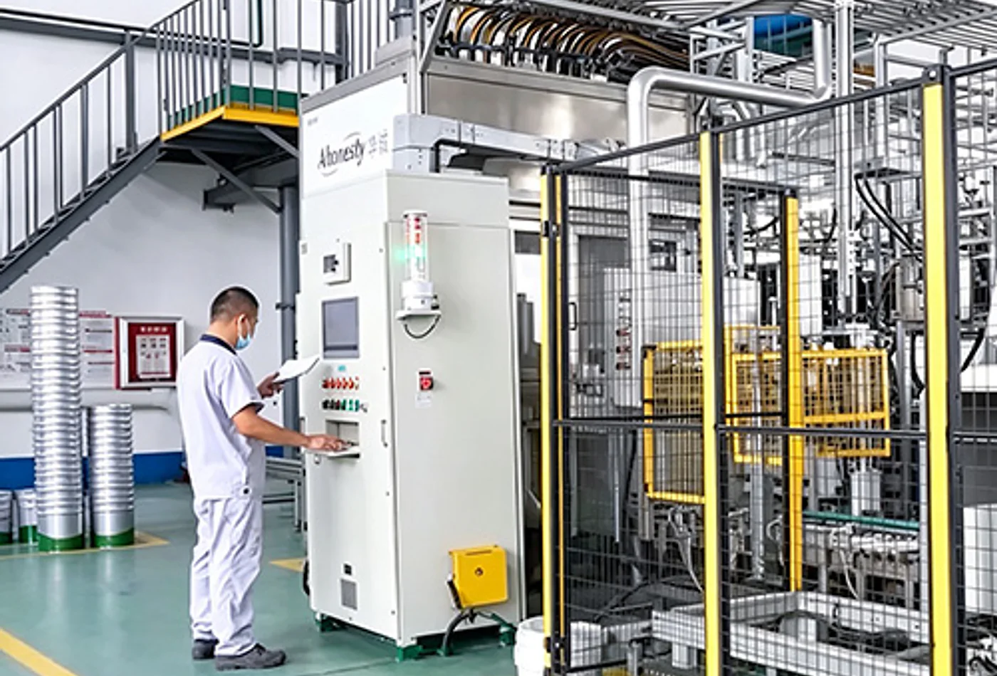Huacheng operator working beside material production equipment