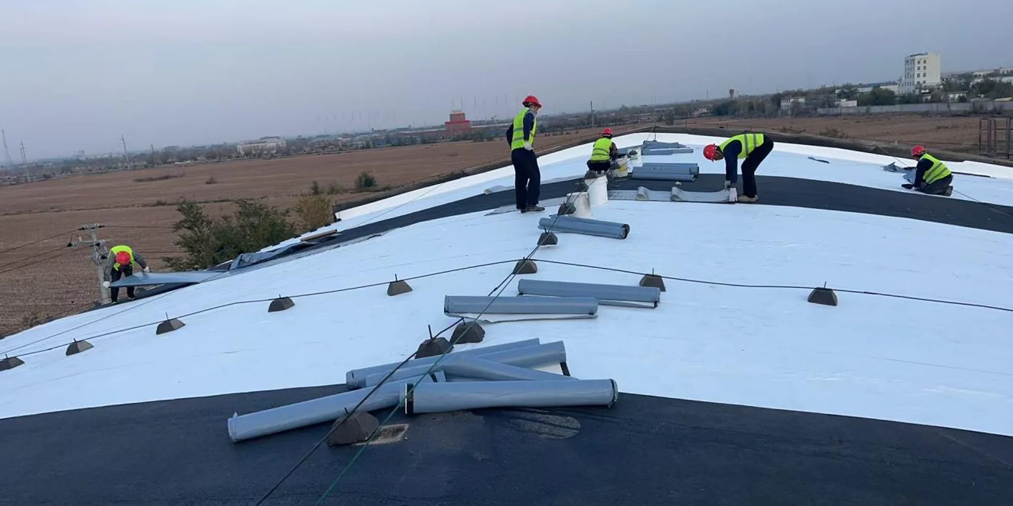 Real Huacheng roof application team installing a cooling material system